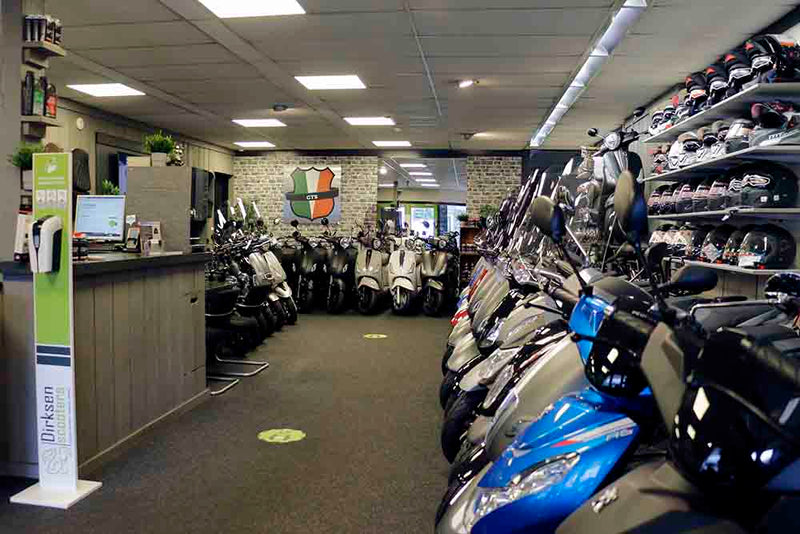 Balie en helmenwand in de winkel van Dirksen Scooters